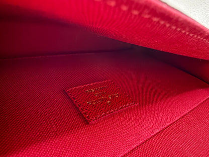 Red textile interior lining of the Louis Vuitton Félicie Pochette with embossed Louis Vuitton stamp