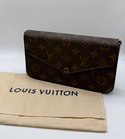 Louis Vuitton Félicie Pochette resting on its original Louis Vuitton dust bag