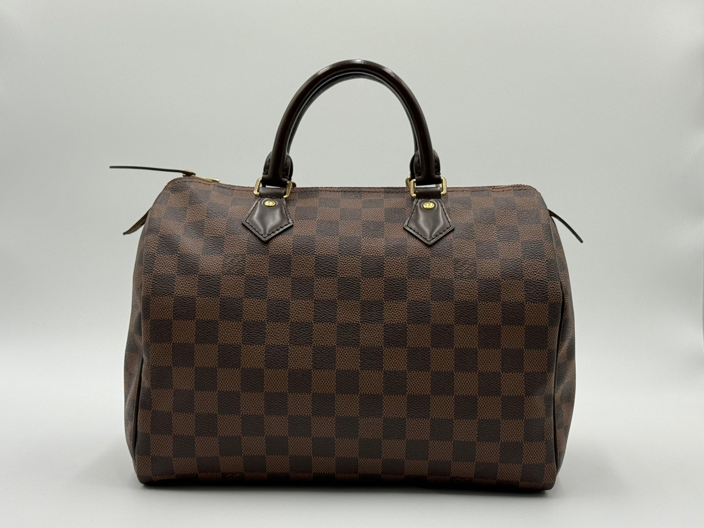 Louis Vuitton Speedy 30 front view showing Damier Ebène checkerboard pattern and gold-tone hardware