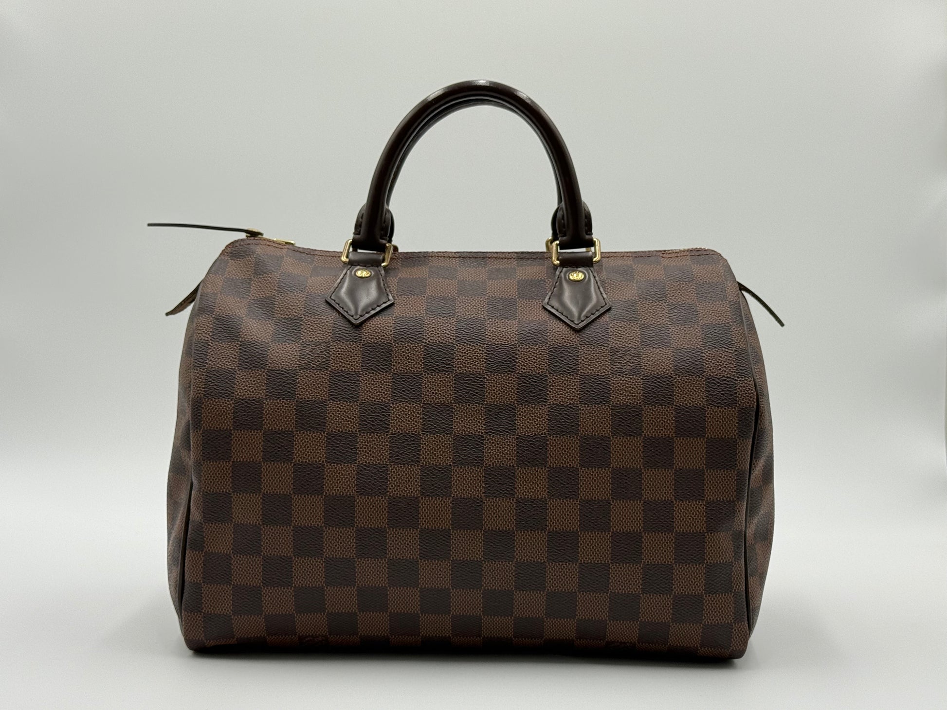 Louis Vuitton Speedy 30 front view showing Damier Ebène checkerboard pattern and gold-tone hardware