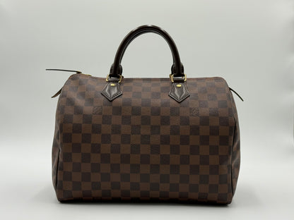 Louis Vuitton Speedy 30 front view showing Damier Ebène checkerboard pattern and gold-tone hardware