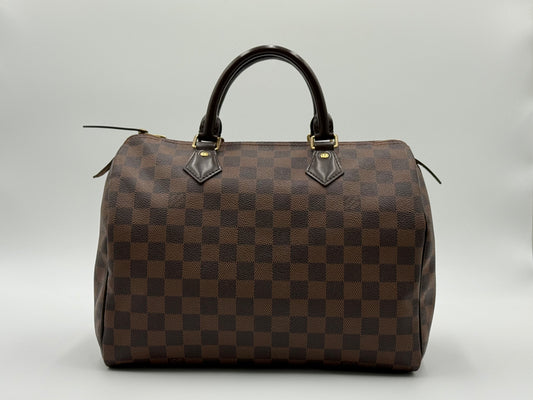 Louis Vuitton Speedy 30 front view showing Damier Ebène checkerboard pattern and gold-tone hardware