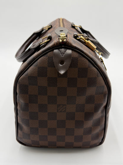 Close-up of the leather handles, gold padlock, and zipper pull on the Louis Vuitton Speedy 30