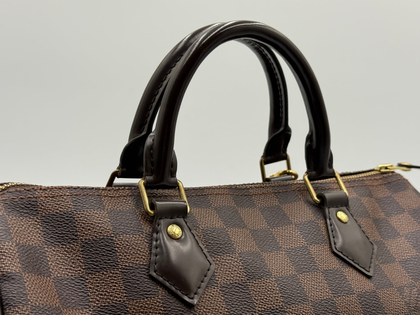 Close-up of the rolled leather handles on the Louis Vuitton Speedy 30