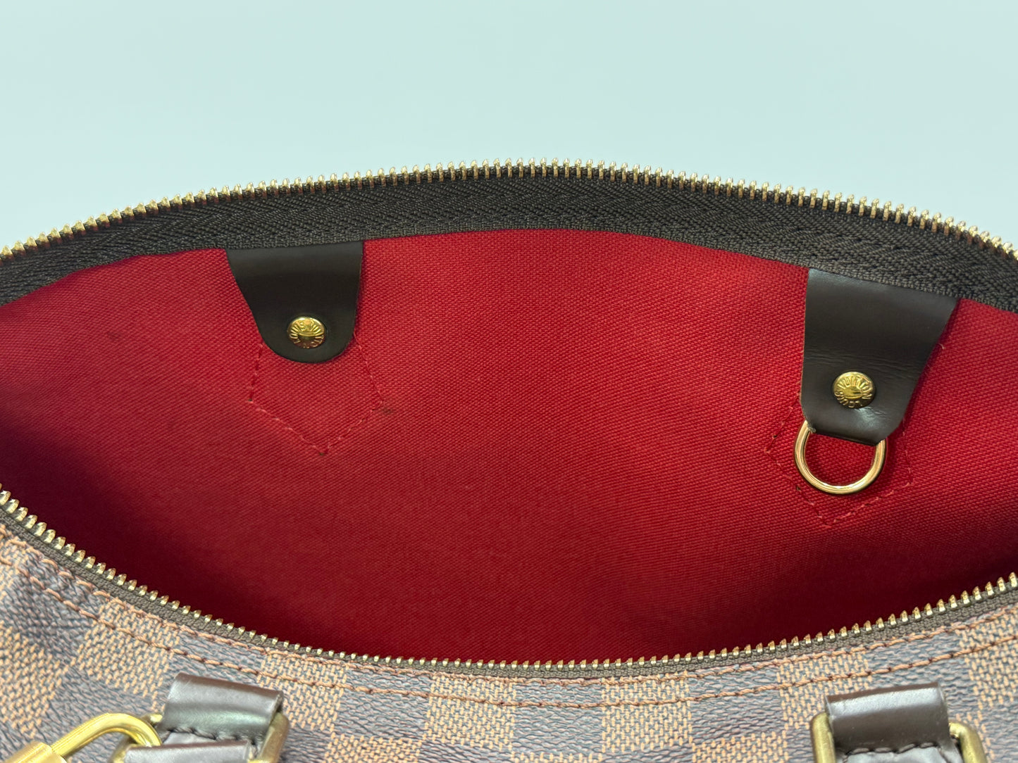 Red textile interior lining of the Louis Vuitton Speedy 30