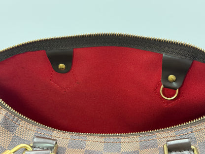 Red textile interior lining of the Louis Vuitton Speedy 30