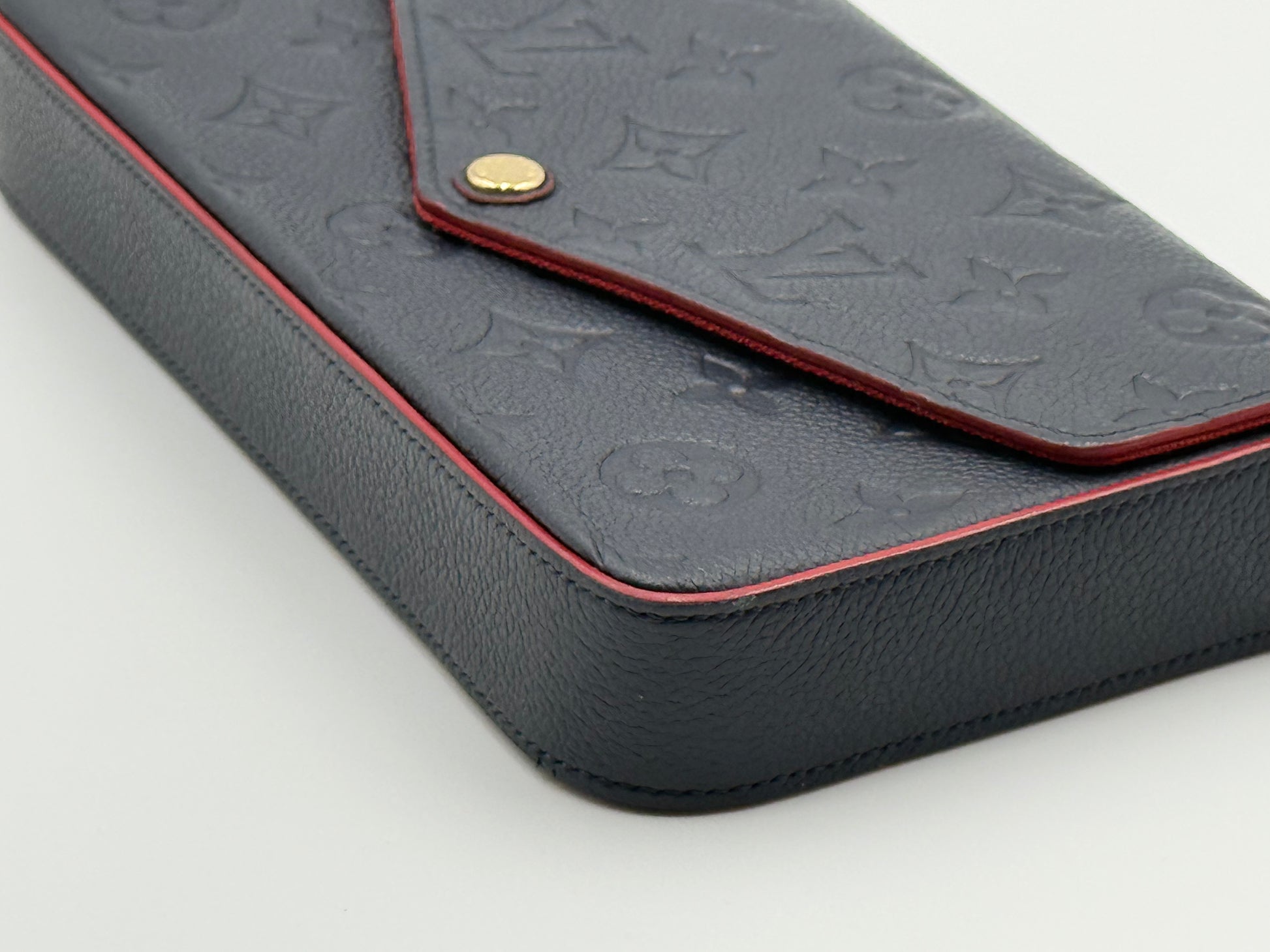 Louis Vuitton Félicie Pochette Empreinte Marine Rouge — flap and gold snap detail