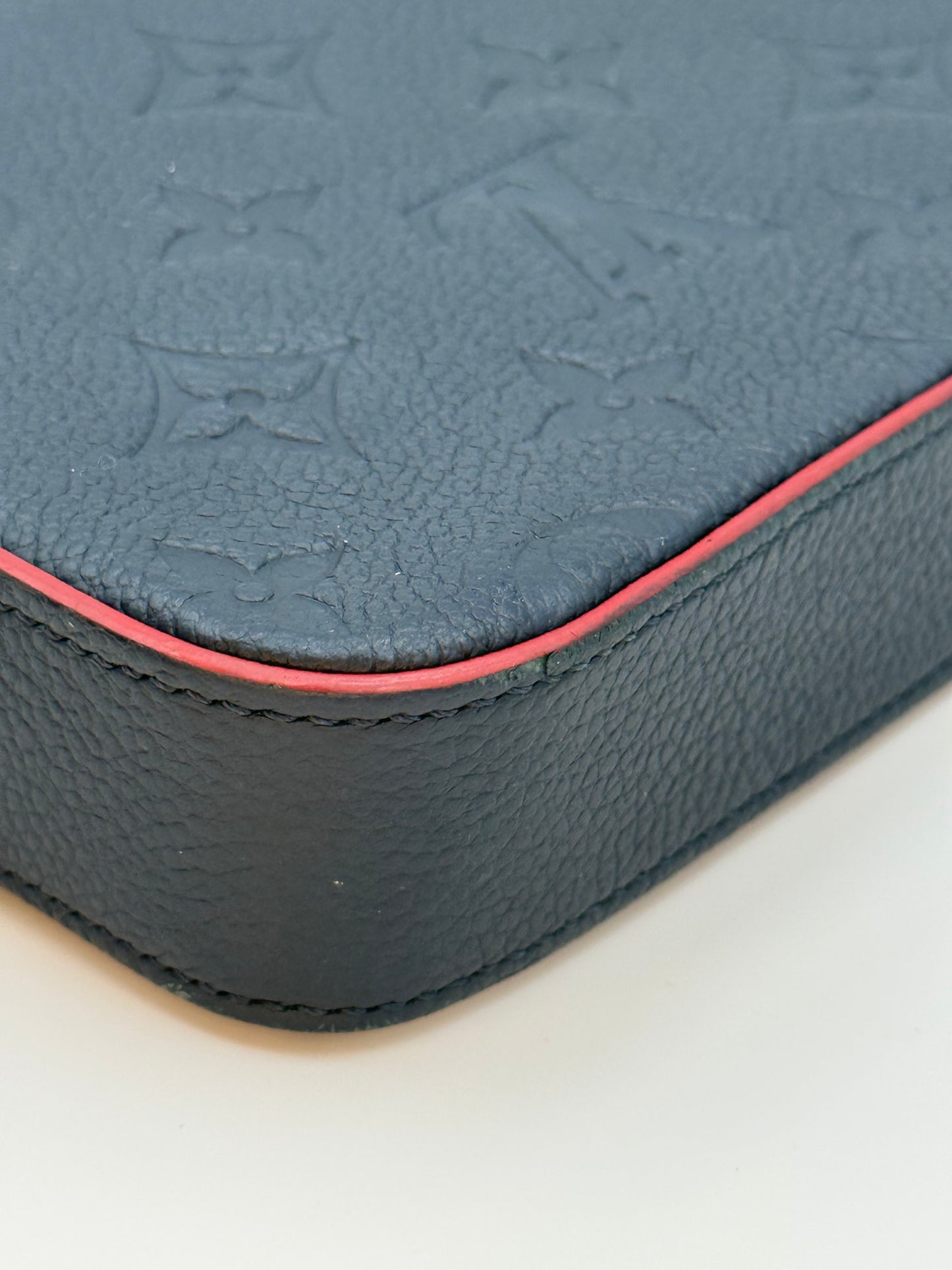 Louis Vuitton Félicie Pochette Empreinte Marine Rouge — corner and red edge paint condition