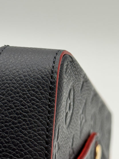 Louis Vuitton Félicie Pochette Empreinte Marine Rouge — close-up of embossed Monogram leather and edge wear