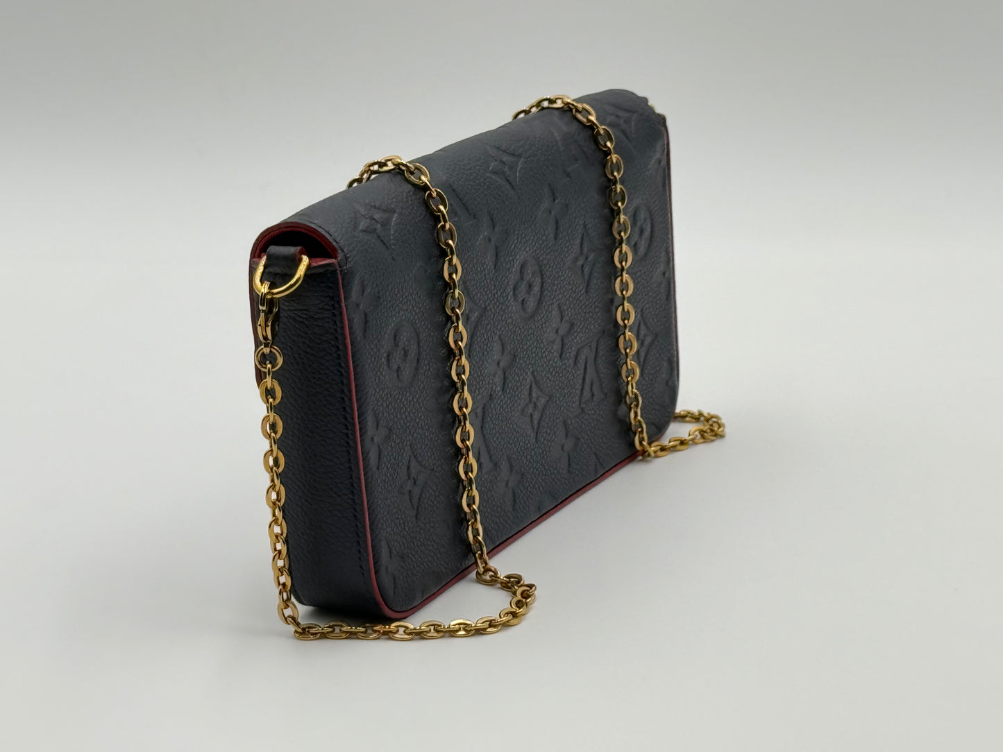 Louis Vuitton Félicie Pochette Empreinte Marine Rouge — side profile with gold-tone chain strap