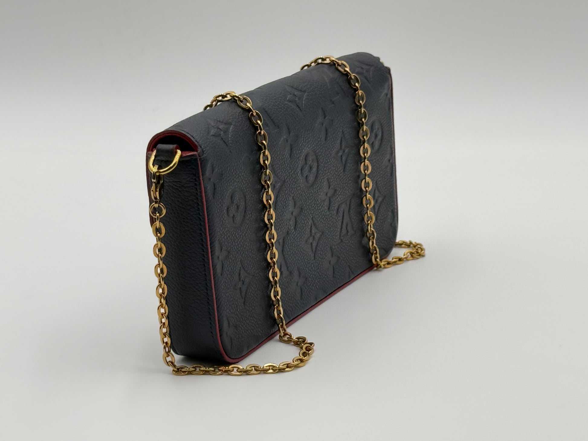 Louis Vuitton Félicie Pochette Empreinte Marine Rouge — side profile with gold-tone chain strap