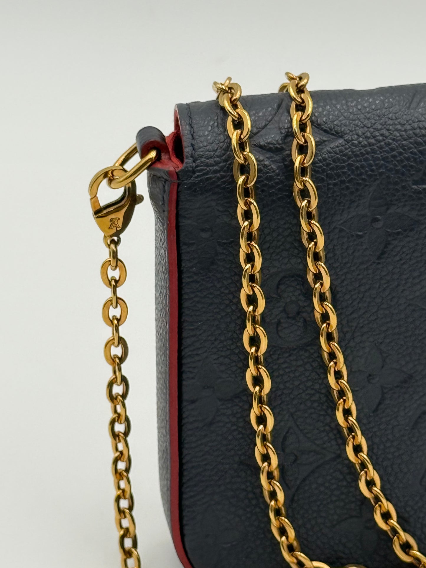 Louis Vuitton Félicie Pochette Empreinte Marine Rouge — worn crossbody with chain strap
