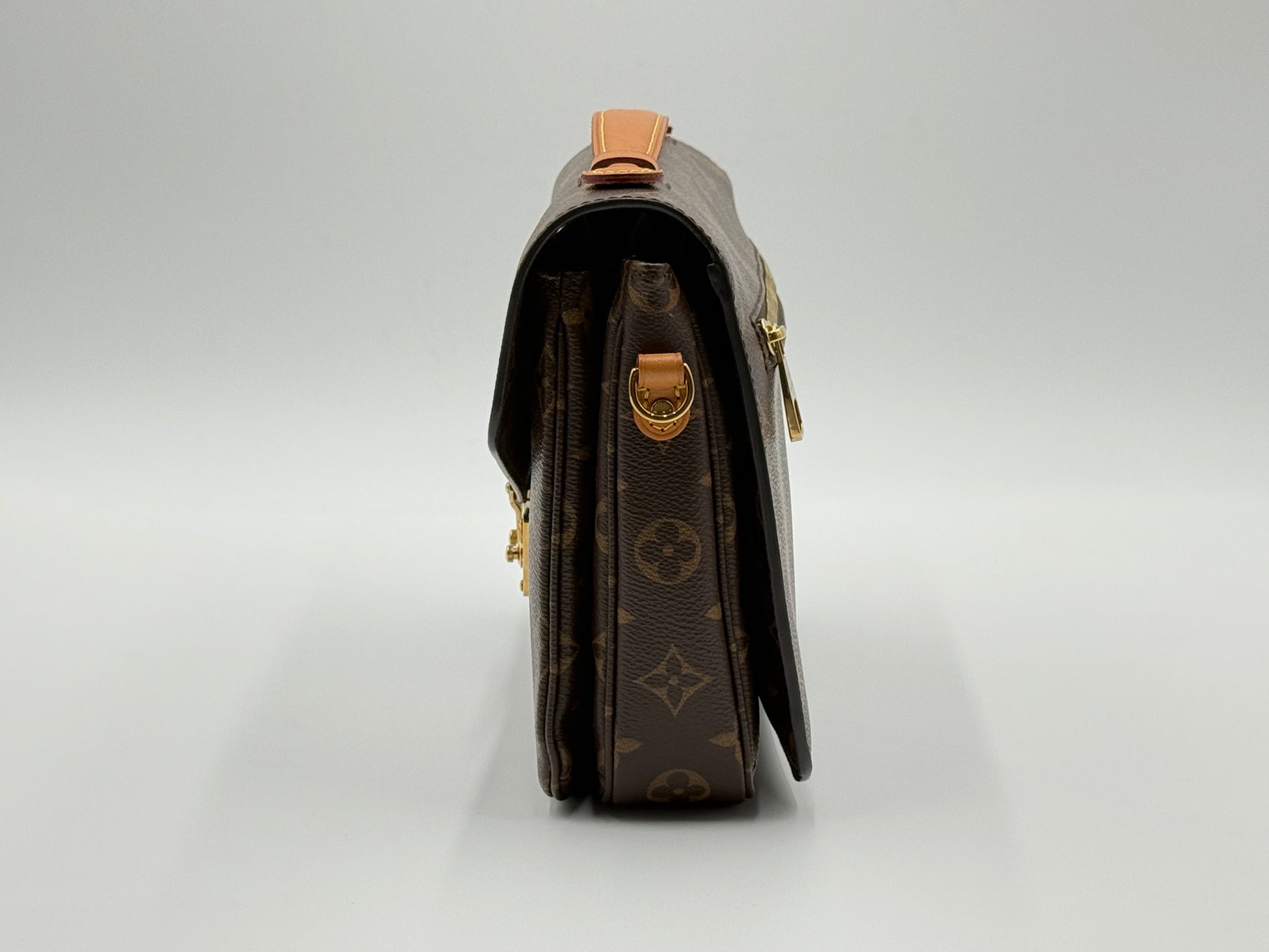 Louis Vuitton Pochette Métis Monogram — angled front view with adjustable leather strap