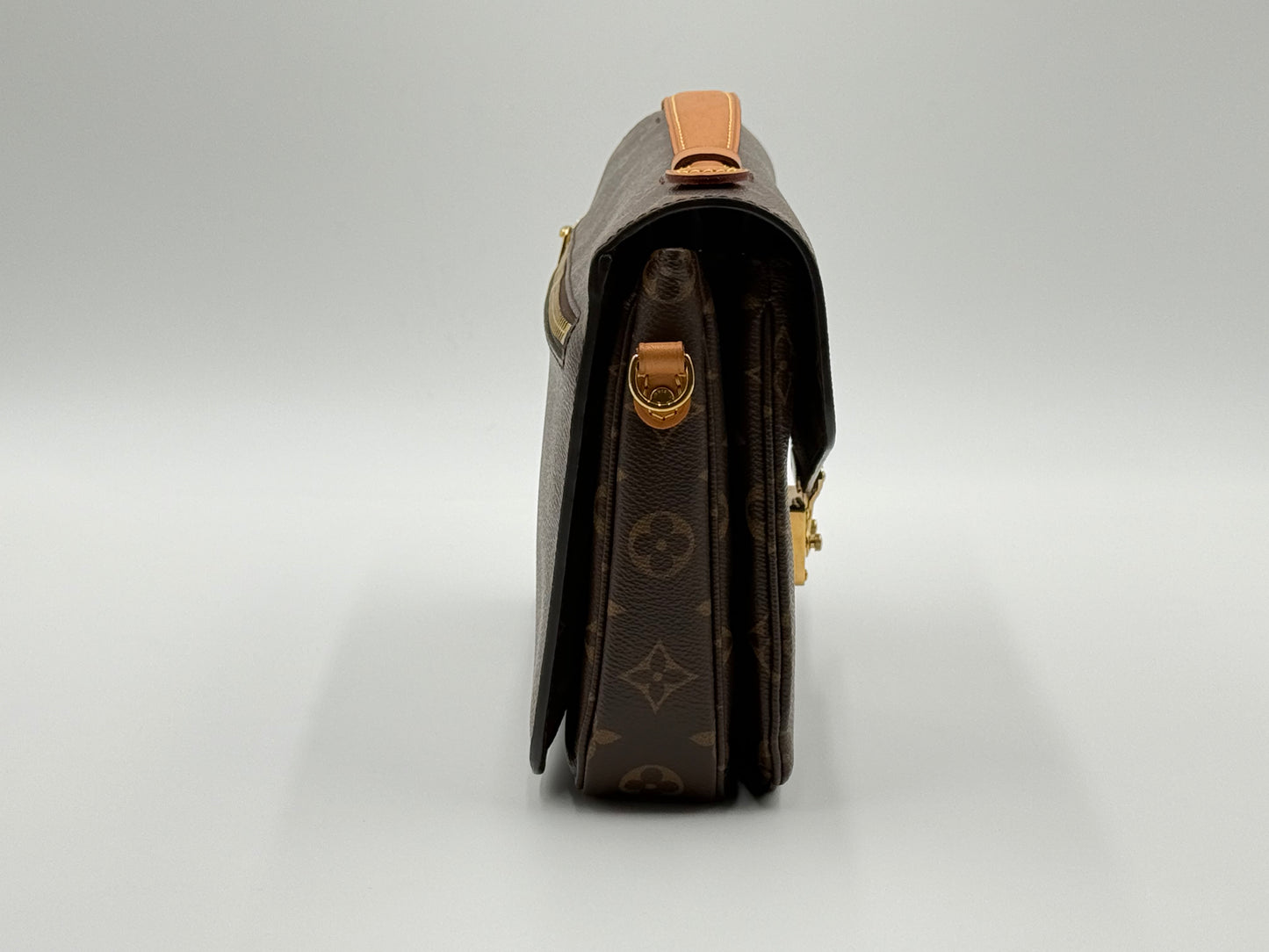 Louis Vuitton Pochette Métis Monogram — angled front view with adjustable leather strap