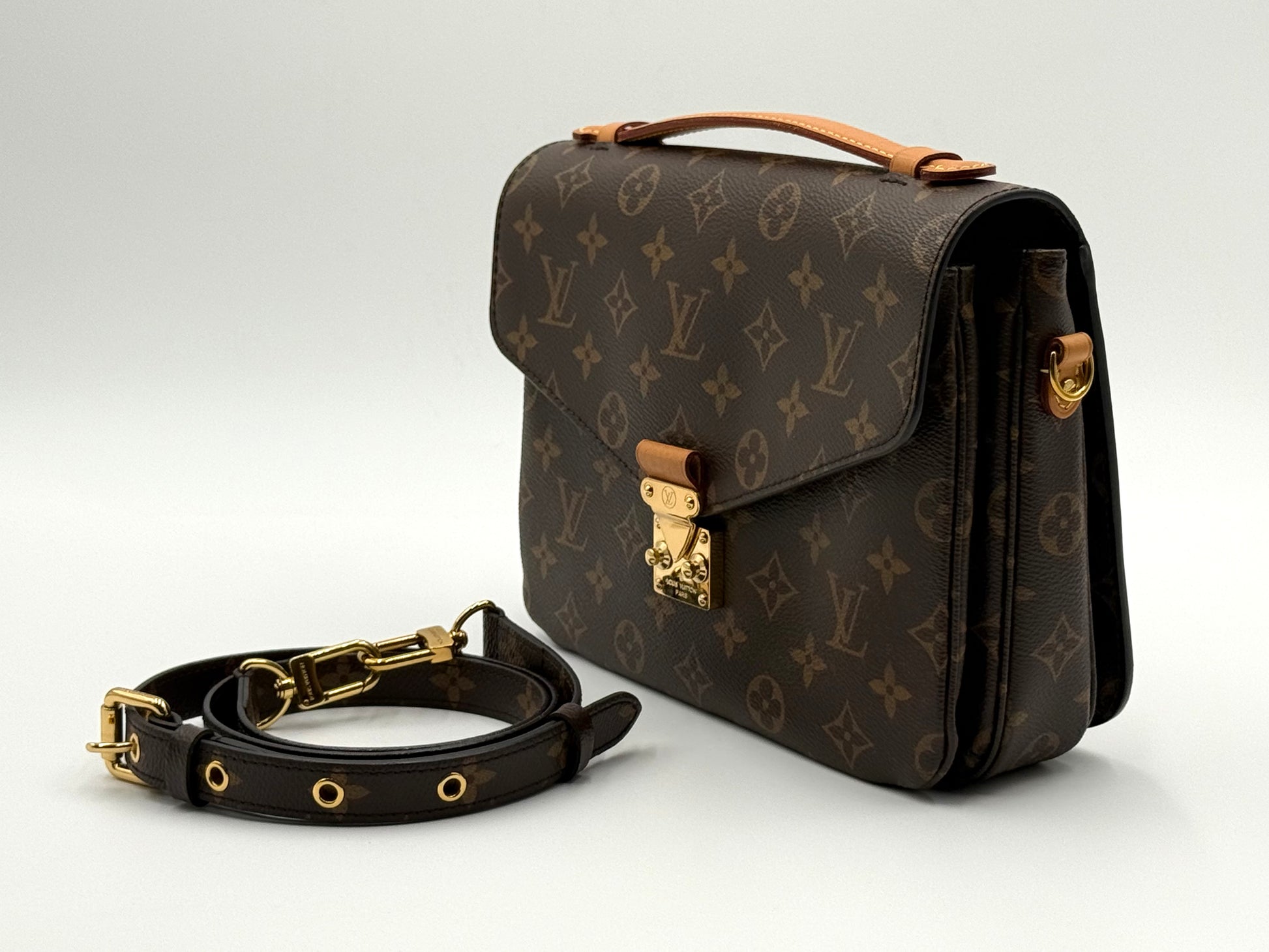 Louis Vuitton Pochette Métis Monogram — angled side view with strap detached