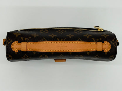 Louis Vuitton Pochette Métis Monogram — flap closed, angled view showing base