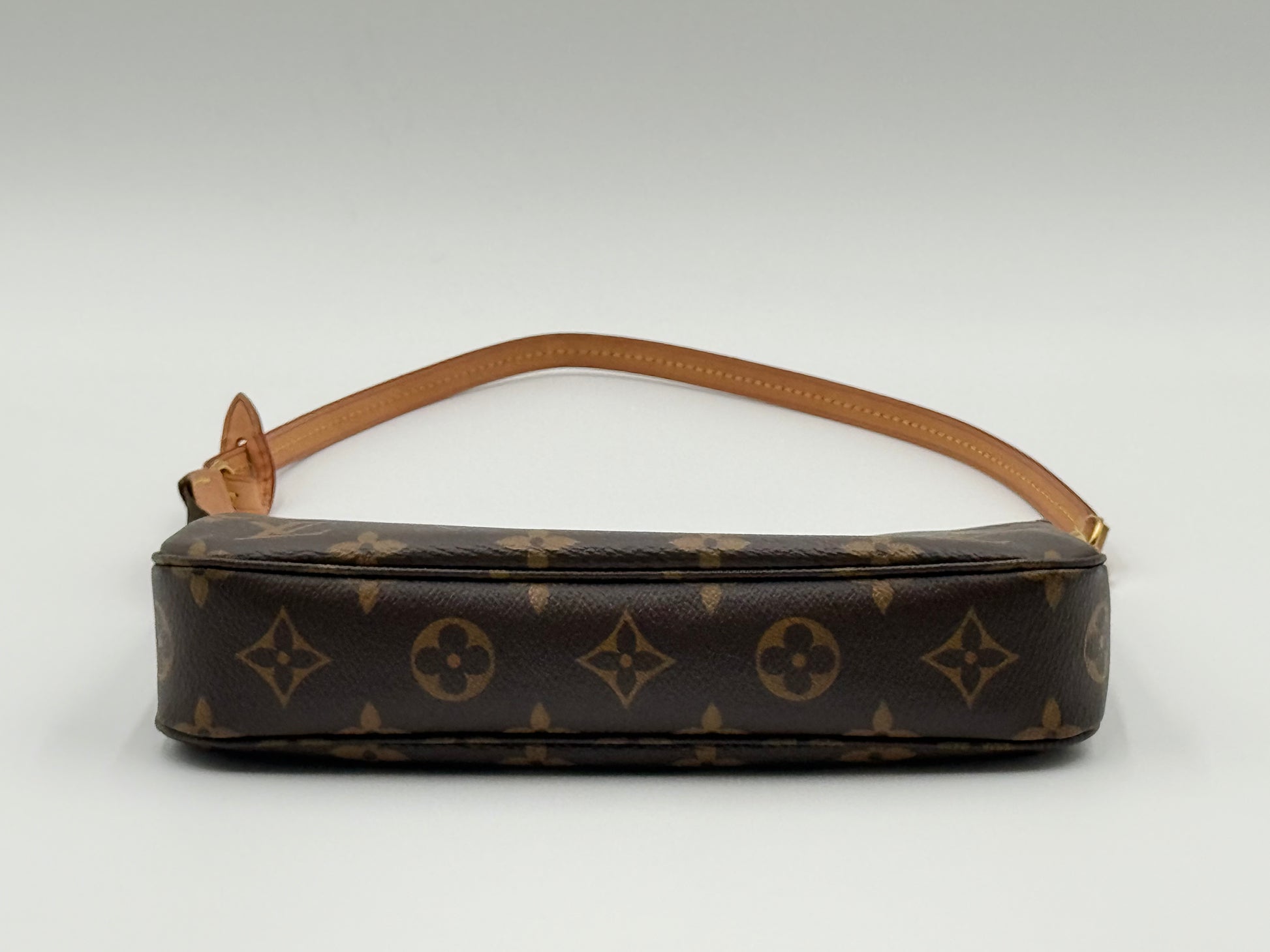 Louis Vuitton Pochette Accessoires Monogram — side profile showing strap attachment